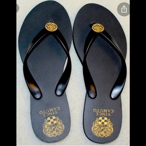 Black flip flop sandals by Vince Camuto